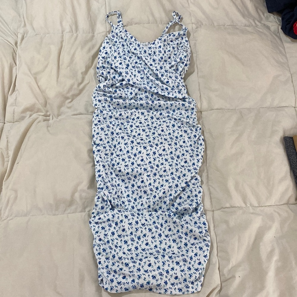 White dress with blue flowers! Goes a little above the knees, hugs body tightly!